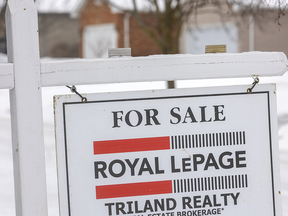 Sale sign in front of the house