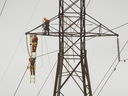 Hydro One technicians work on a transmission tower. The Ontario utility has a new chief executive.