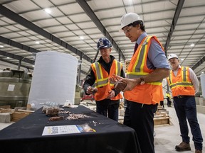 Prime Minister Justin Trudeau, right, speaks with Vincent Laniece, with Vital Metals during a tour of the Vital Metals rare earths element processing plant in Saskatoon, on Monday, January 16, 2023.