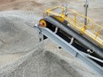 Ore falls from a conveyor onto a stockpile at a lithium mine site in Australia.