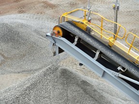 Ore falls from a conveyor onto a stockpile at a lithium mine site in Australia.