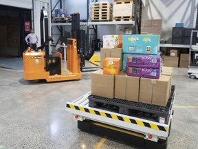 A robot forklift and package mover are seen at Deloitte Canada's Smart Factory AI robotic warehouse showroom Tuesday, January 24, 2023 in Montreal.