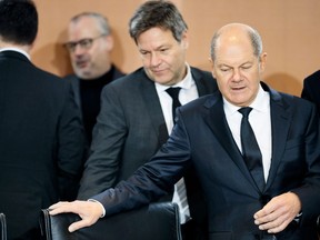 German Chancellor Olaf Scholz, right, and German Economy and Climate Minister Robert Habeck, center, take their seats during weekly cabinet meeting of the German government at the chancellery in Berlin, Germany, Wednesday, Jan. 25, 2023.