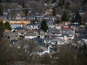 A condo building under construction surrounded by houses in Vancouver, B.C.