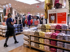 People shop at a Uniqlo store in New York City.