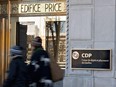 People walk by the headquarters of the Caisse de dépôt et placement du Québec inside the Price Building in Quebec.