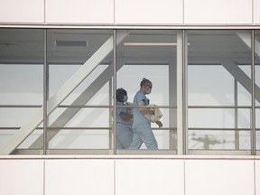 Health-care workers walk across a sky bridge at a hospital in Montreal.