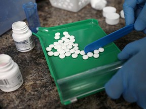 A pharmacist counts prescription drugs at the CentreTown Pharmacy in Ottawa.