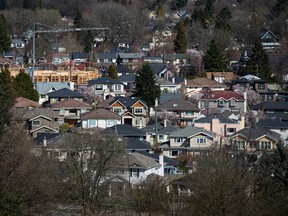 A condominium building is seen under construction surrounded by homes in Vancouver, BC on Friday March 30, 2018.  Canada's banking regulator is expected to make an announcement this morning regarding the interest rate used in a key stress test for uninsured mortgages.  THE CANADIAN PRESS/