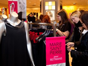 Customers check the racks as retailer Reitman launches a line featuring designs by Marie Saint Pierre, in Montreal in 2011.