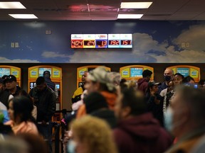 People wait in line at "The Lotto Store at Primm" just inside the California border Friday, Jan. 13, 2023, near Primm, Nev. Mega Millions players will have another chance Friday night to end months of losing and finally win a jackpot that has grown to $1.35 billion.