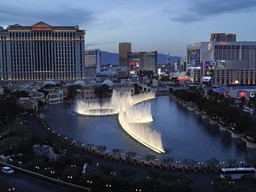 FILE - In this April 4, 2017, file photo, fountains erupt along the Las Vegas Strip in Las Vegas. A federal lawsuit has been filed in Nevada seeking class-action status for a complaint that several of the biggest hotel-casino operators on the Las Vegas Strip have illegally fixed and inflated guest room rate prices.