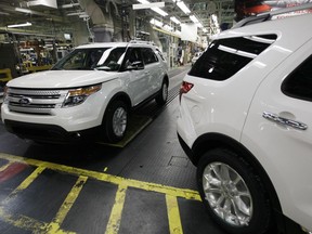 FILE - Plant employees drive 2011 Ford Explorer vehicles off the assembly line at Ford's Chicago Assembly Plant in Chicago, Dec. 1, 2010. The U.S. government's road safety agency has closed a more than six-year investigation into Ford Explorer exhaust odors, determining that the SUVs don't emit high levels of carbon monoxide and don't need to be recalled.