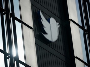 FILE - A Twitter logo hangs outside the company's offices in San Francisco, on Dec. 19, 2022. The company is auctioning off memorabilia, fancy office furniture and professional kitchen equipment from its San Francisco offices, where large spaces now sit empty and free meals are a relic of the past.Even when all added up, the money raised from the auction, which closes Wednesday, Jan. 18, 2023, is unlikely to make a dent in Twitter's financial obligations.