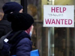 FILE - A help wanted sign is displayed outside of a hair salon in Chicago, Thursday, Jan. 5, 2023. If you're looking for a job or aiming to get a raise this year, a new factor may come into play. It's called pay transparency, a growing trend for companies to reveal what a job opening or current position pays.