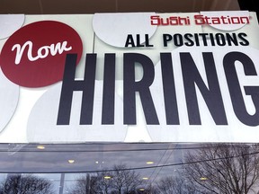 FILE - A hiring sign is displayed at a restaurant in Rolling Meadows, Ill., Tuesday, Dec. 27, 2022. On Wednesday, the Labor Department reports on job openings and labor turnover for November.
