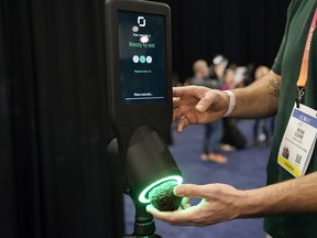 An exhibitor demonstrates the OneThird avocado ripeness checker during CES Unveiled before the start of the CES tech show, Tuesday, Jan. 3, 2023, in Las Vegas. More than a thousand startups are showcasing their products at the annual CES tech show in Las Vegas, hoping to create some buzz around their gadgets and capture the eyes of investors who can help their businesses grow.