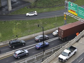 FILE - Traffic is seen near the entrance to the Holland Tunnel in Jersey City, N.J., April 27, 2017. State and local governments will soon gain new flexibility to spend billions of federal coronavirus relief dollars on things not directly related to the pandemic, including new roads and bridges and aid to people affected by wildfires, floods and other natural disasters.