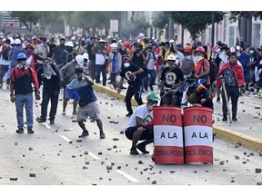 Demonstrators and the riot police during clashes in Lima on Jan. 24.