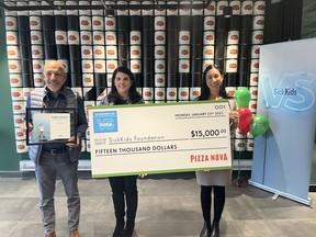 Domenic Primucci, president of Pizza Nova presents a $15,000 cheque to Katie McHugh-Escobar, Director of Community Events at SickKids Foundation and Sheryl Yip, Manager, Sponsorships & Cause Marketing at SickKids Foundation on January 23, 2023