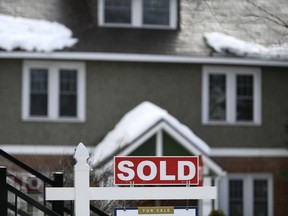 A for sale sign outside a home indicates that it has been sold, in Ottawa, on Monday, March 1, 2021. Canada's banking regulator is launching public consultations on rules around mortgage lending as it says loan risks have increased considerably since the start of the COVID-19 pandemic.