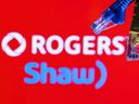 Ethernet cables are seen in front of Rogers and Shaw Communications logos.
