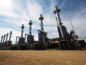 Rows of steam generators line a road at an oilsands site in Alberta.