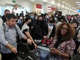 Passengers from Sunwing airlines line up for check-in at Cancun International Airport after many flights to Canada had been canceled because of the severe winter weather conditions on Dec. 27, 2022.