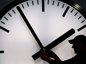 Silhouette of a large clock and man