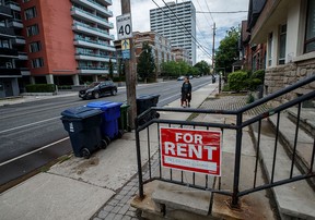A for-rent sign outside a home in Toronto. Many families here find themselves spending more than half of their income on rent.
