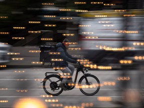 A food delivery worker rides a bike in downtown Vancouver, on Thursday, December 23, 2021. Gig work normally rises during a recession, but economists say a tight labour market and continued high inflation mean that might not happen in 2023.