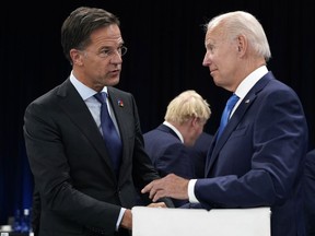 FILE - Netherland's Prime Minister Mark Rutte, left, speaks with U.S. President Joe Biden during a round table meeting at a NATO summit in Madrid, Spain, June 29, 2022. Biden is set to host Dutch Prime Minister Mark Rutte for talks. The U.S. administration is looking to persuade the Netherlands to further limit China's access to advanced semiconductors with export restrictions.