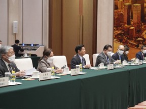 In this handout photo provided by the Malacanang Presidential Photographers Division, Philippine President Ferdinand Marcos Jr., center, and officials meet China's Chairman of the Standing Committee of the National People's Congress Li Zhanshu, not shown, at the Great Hall of the People, in Beijing, China, Wednesday Jan. 4, 2023. (Malacanang Presidential Photographers Division via AP)