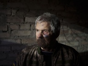 Anatolii Kaharlytskyi, 73, stands inside his house, heavily damaged after a Russian attack in Kyiv, Ukraine, Monday, Jan. 2, 2023. Kaharlytskyi was injured and his daughter Iryna died in the attack on Dec. 31, 2022.