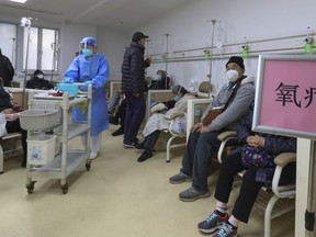 In this photo released by Xinhua News Agency, Patients wearing face masks receive oxygen therapy at a community healthcare institution in Shanghai, China, Monday, Jan. 5, 2023. As COVID-19 rips through China, other countries and the WHO are calling on its government to share more comprehensive data on the outbreak, with some even saying many of the numbers it is reporting are meaningless.