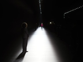 A fashion show usher waits prior to the start of the Dior menswear Fall-Winter 2023-24 collection presented in Paris, Friday, Jan. 20, 2023.