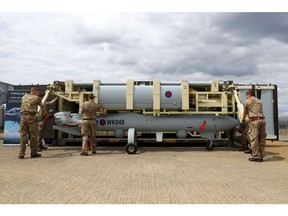 Soldiers, serving with the British army, pack a Thales Watchkeeper WK450 unmanned aerial vehicle, manufactured by Thales SA, into a container on day two of the Farnborough International Airshow (FIA) 2018 in Farnborough, U.K., on Tuesday, July 17, 2018. The air show, a biannual showcase for the aviation industry, runs until July 22.