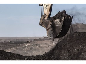 An excavator scoops up coal in an open pit at the Tavan Tolgoi coal deposit developed by Erdenes Tavan Tolgoi JSC, a unit of Erdenes Mongol LLC, in Tsogtsetsii, Ömnögovi Province, Mongolia, on Monday, Sept. 24, 2018. Mongolia has expanded its coal reserves by 24 percent at the state-owned giant Tavan Tolgoi mine to 6.34 billion tons, according to Erdenes Tavan Tolgoi Chief Executive Officer Gankhuyag Battulga. Mongolian lawmakers in June approved a plan to sell up to 30% of the coal mine in the Gobi desert, the latest attempt to develop what's anticipated to be massive coking and thermal coal deposit. Photographer: Taylor Weidman/Bloomberg