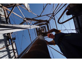 A worker positions pipework on the oil drilling platform at the oil and gas field processing and drilling site operated by Ukrnafta PJSC in Boryslav, Lviv region, Ukraine, on Thursday, July 4, 2019. Ukrnafta co-owner, Naftogaz JSC, the largest gas supplier in the country of 42 million people, is seeking funds to accelerate gas purchases ahead of the heating season and a potential disruption of gas transit by Russia's Gazprom PJSC from the start of 2020. Photographer: Vincent Mundy/Bloomberg