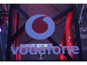 A Vodafone Group Plc logo sits on the company's 5G wireless exhibition stand at the Gamescom computer games industry event in Cologne, Germany, on Tuesday, Aug. 20, 2019. Gamescom is the world's largest gaming convention and runs from August 20 to 24. Photographer: Krisztian Bocsi/Bloomberg