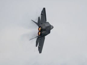 A U.S. Air Force F-22 Raptor fighter jet, manufactured by Lockheed Martin Corp., performs a maneuver during the Singapore Airshow at the Changi Exhibition Centre in Singapore, on Tuesday, Feb. 11, 2020. Plane makers and airlines are exploring new designs to reduce fuel burn and cut carbon emissions in a warming climate. Blending the wings with the fuselage to cut drag is one of several possible solutions. Photographer: SeongJoon Cho/Bloomberg