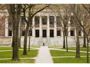 A pedestrian walks on a university campus in Cambridge, Massachusetts. Photographer: Adam Glanzman/Bloomberg