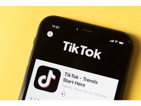 The download page for ByteDance Ltd.'s TikTok app is arranged for a photograph on a smartphone in Sydney, New South Wales, Australia, on Monday, Sept. 14, 2020. Oracle Corp. is the winning bidder for a deal with TikTok's U.S. operations, people familiar with the talks said, after main rival Microsoft Corp. announced its offer for the video app was rejected.