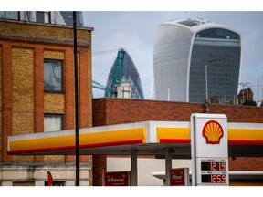 A Royal Dutch Shell Plc petrol station in view of skyscrapers in the financial district of the City of London, U.K., on Tuesday, Feb, 2, 2021. Royal Dutch Shell Plc, which reports results on Thursday, has agreed to buy Ubitricity expanding its investments in the transition into cleaner fuels.