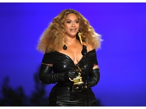 Beyoncé lifting a Grammy in 2021.(Photo by Kevin Winter/Getty Images for The Recording Academy) Photographer: Kevin Winter/Getty Images North America