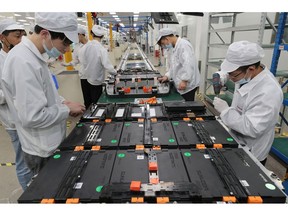 Employees work on electric vehicle battery system at a workshop of Sunwoda Electric Vehicle Battery in Nanjing, China.  Photographer: Xu Congjun/Visual China Group/Getty Images