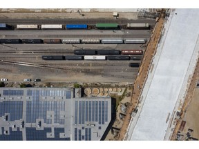 A rail yard and solar panels adjacent to the Sixth Street Viaduct replacement project in Los Angeles, California, U.S. on Tuesday, April 6, 2021. The Ribbon of Light is the name of the ten arches that will make up the new Sixth Street Viaduct connecting downtown L.A.'s Arts District with Boyle Heights.