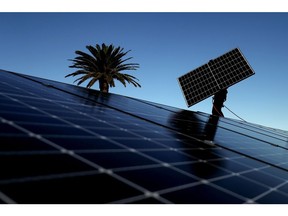 A Solarpro employee installs LG Electronics Inc. NeON R 370W solar panels onto the rooftop of a residential property in Sydney, Australia, on Monday, May 17, 2021. Australia is the global leader in generating electricity from the sun. Some 27% of buildings had a solar system on their roof at the end of 2020, the highest proportion in the world, according to figures from BNEF. Photographer: Brendon Thorne/Bloomberg
