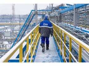A worker walks along an access platform at the Comprehensive Gas Treatment Unit No.3 of the Gazprom PJSC Chayandinskoye oil, gas and condensate field, a resource base for the Power of Siberia gas pipeline, in the Lensk district of the Sakha Republic, Russia, on Monday, Oct. 11, 2021. Amid record daily swings of as much as 40% in European gas prices, Russian President Vladimir Putin made a calculated intervention to cool the market last week by saying Gazprom can boost supplies to help ease shortages.