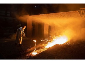 A worker uses a ladle to collect a sample of molten steel from the blast furnace at the Cherepovets Steel Mill, operated by Severstal PJSC, in Cherepovets, Russia, on Friday, Dec. 3, 2021. Even if the recently-identified omicron variant proves less deadly than feared, traders are weighing a weakening growth outlook that could hurt demand for industrial commodities in the months ahead. Photographer: Andrey Rudakov/Bloomberg